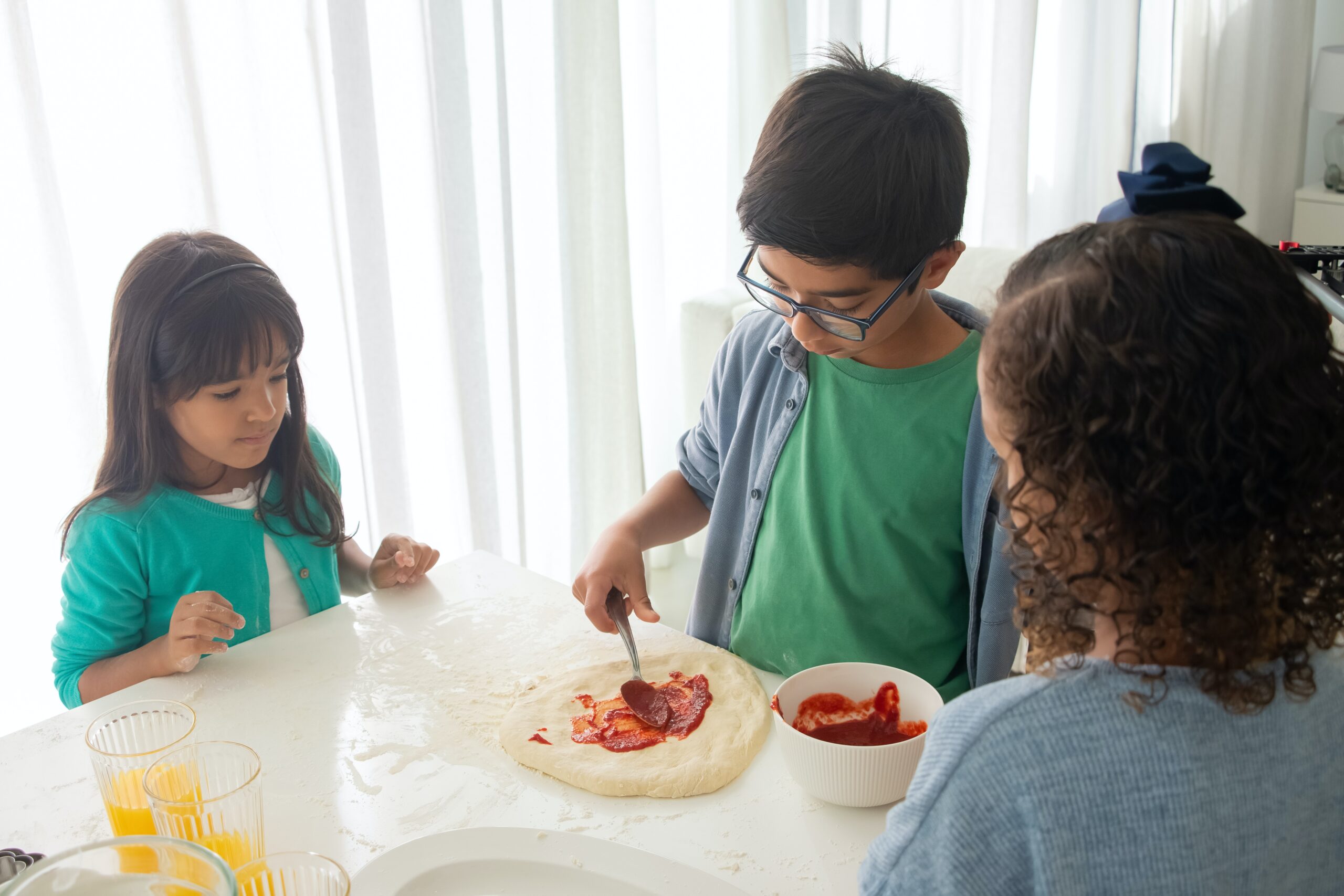 Kids making their own pizza